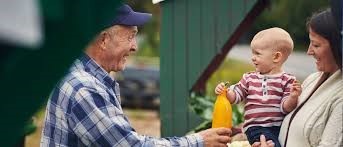 older gentleman talk to little boy & mom